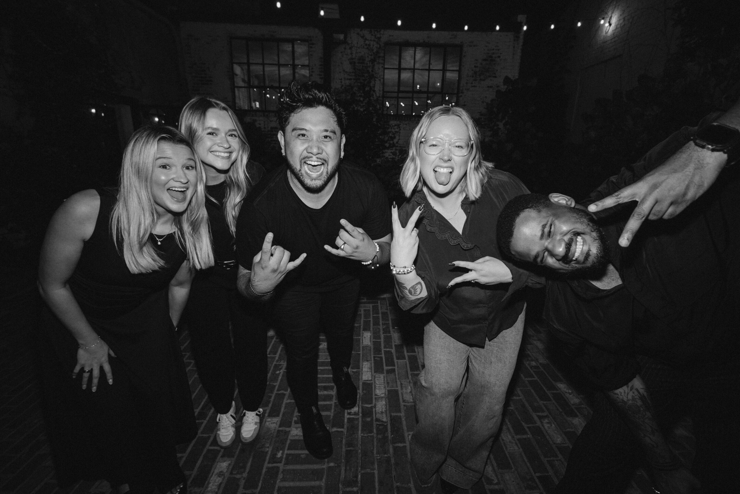 Charleston wedding vendors, including photographer Ean Cuenca, smiling and making silly faces at the reception